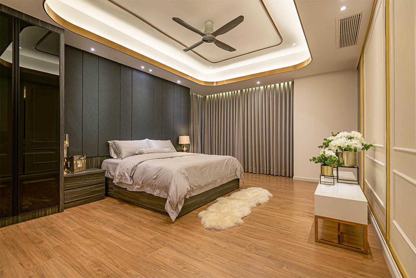 Modern luxurious bedroom with wooden floor, white wall panels, and ceiling aircon