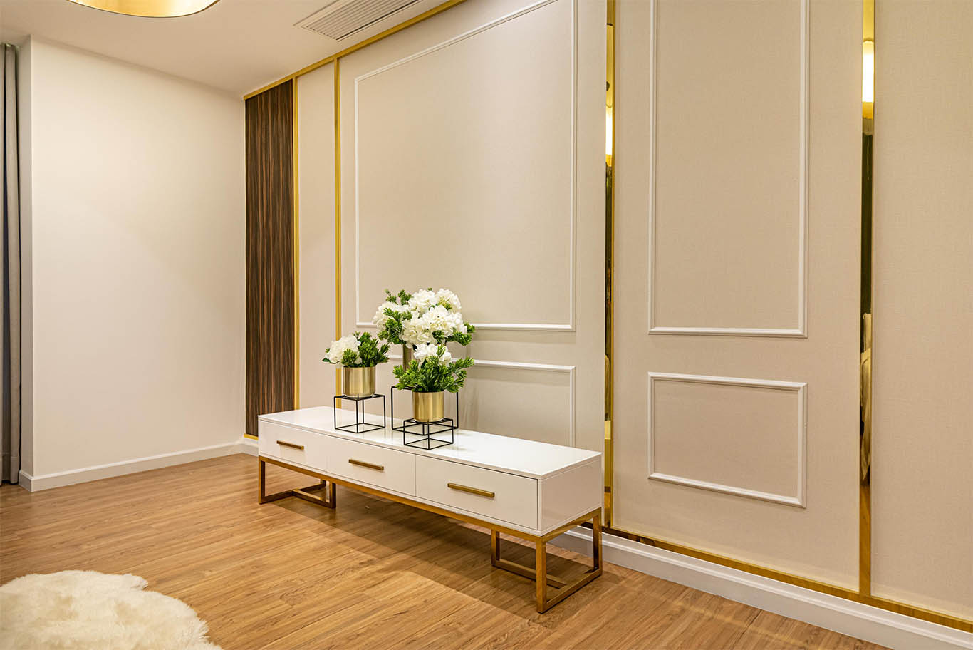 White wall panels and cabinet with gold line and white flower decoration with gold vase