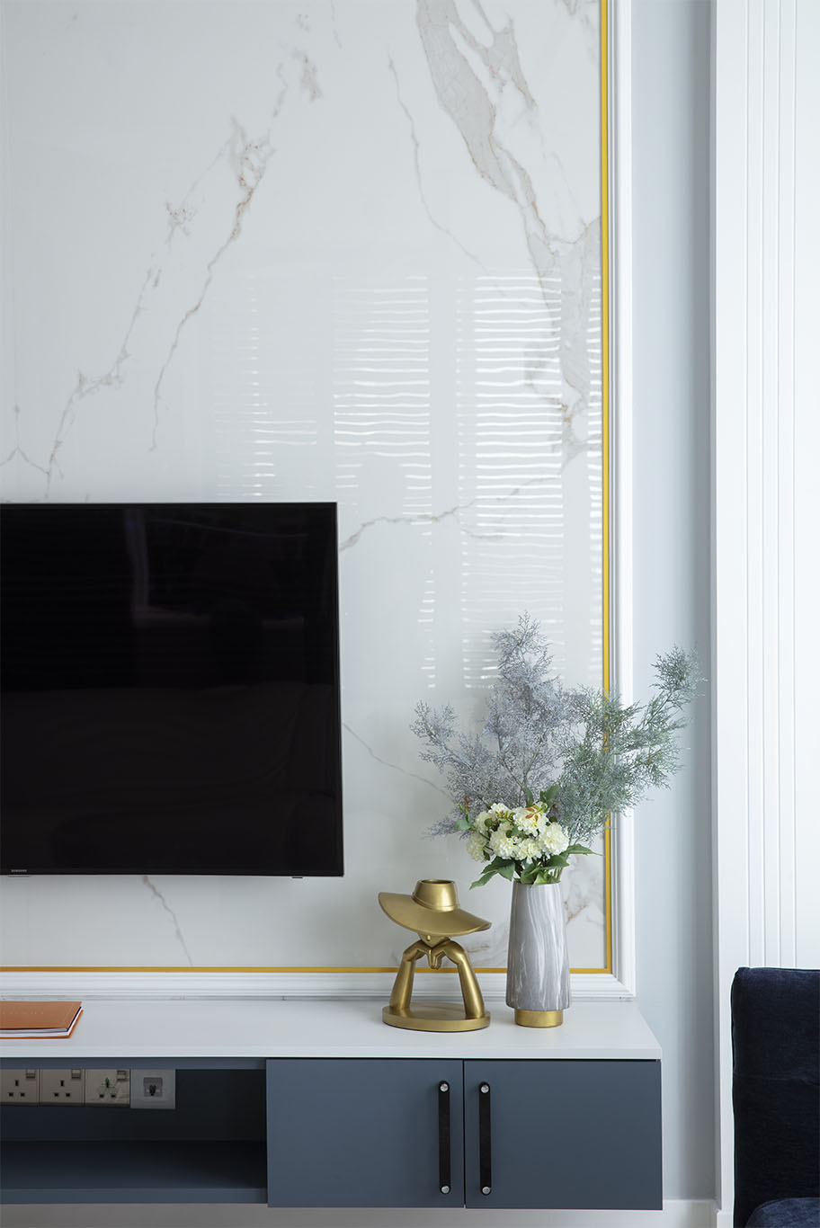 white marble wall with gold line, and soft blue color flower decoration for living room