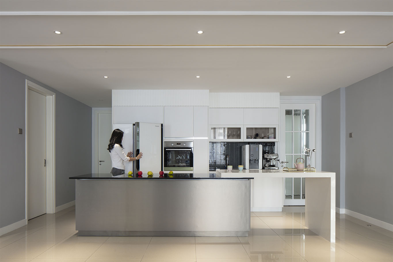 Minimalist open kitchen design with soft baby blue theme, with white kitchen cabinet with built in oven, white fridge, round ceiling light, and black and white countertop