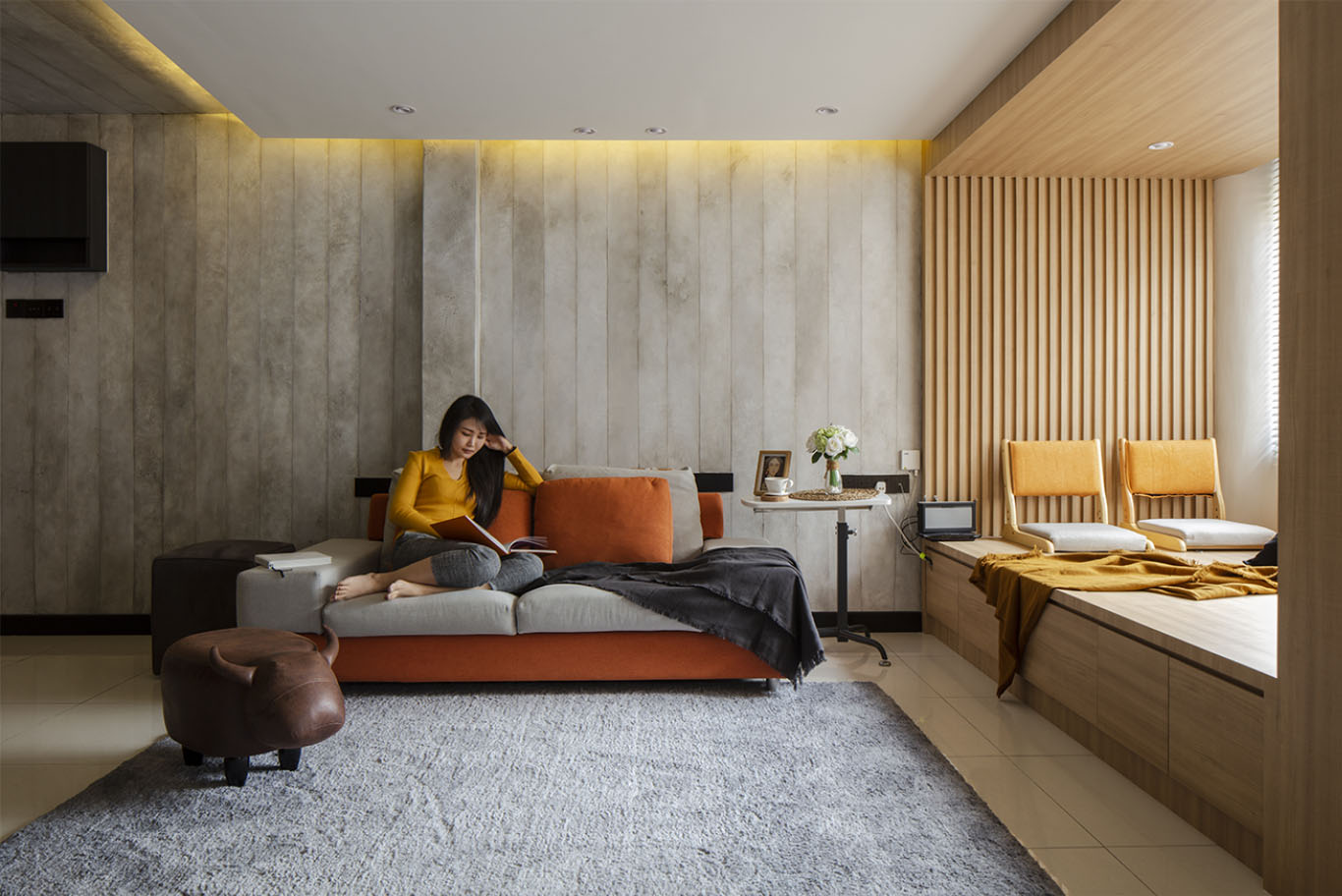 Modern japandi interior design with rustic wall panels, hidden gold ceiling light, wooden window seat with a Zaisu, Japanese chair with a back and no legs
