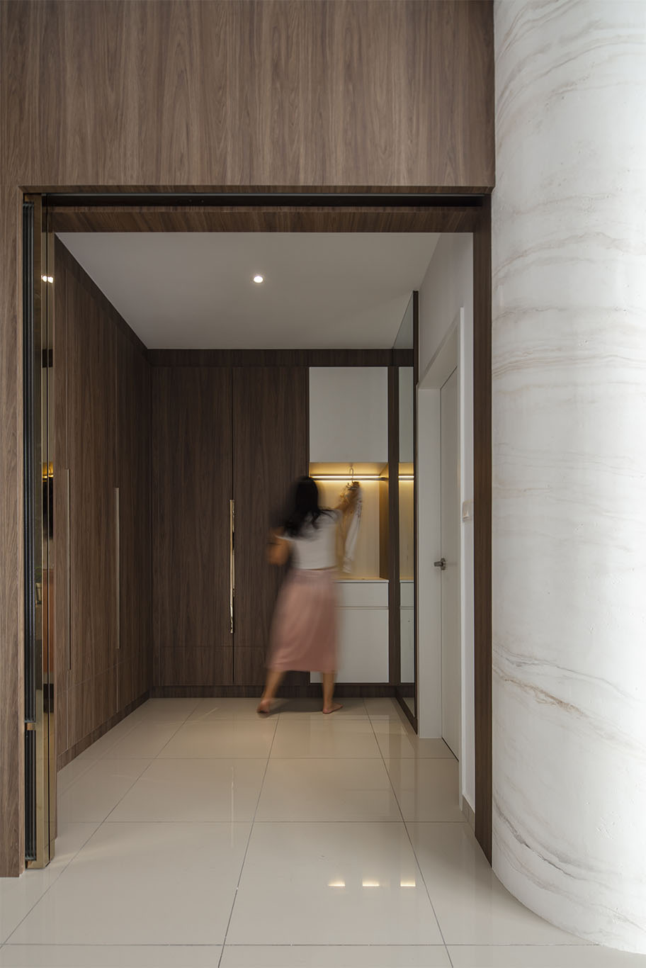 Grande Rhapsody hidden walk in closet with wooden cupboard Mieux interior design