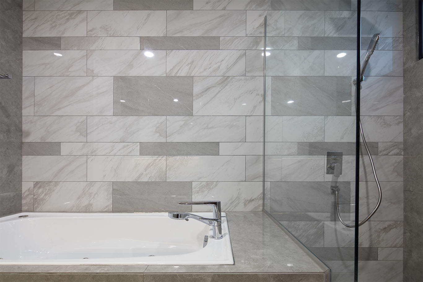 MIEUX The White Royale bathroom with white tub and grey marble tiles wall side view mieux interior design