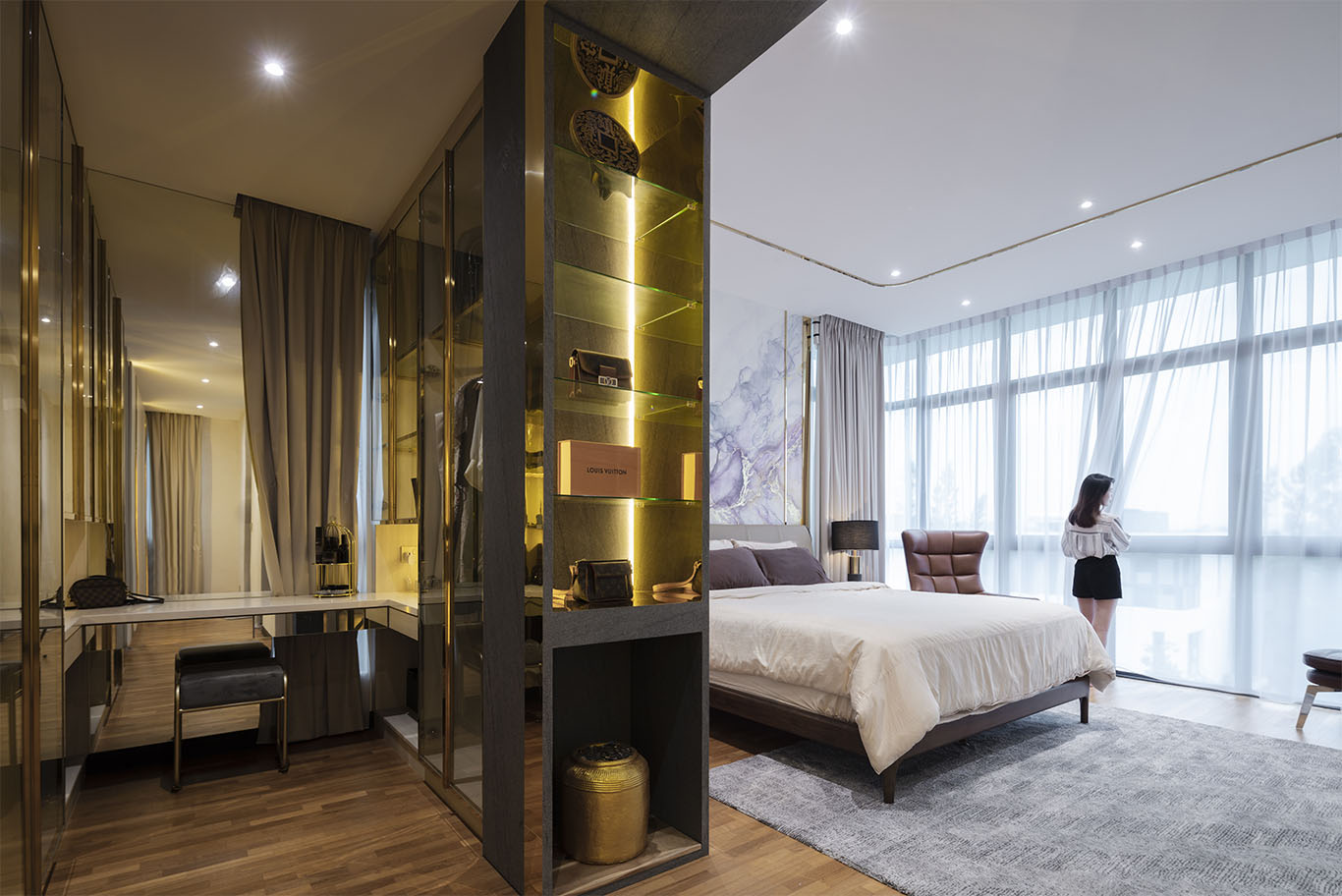 MIEUX La Famillie De Lee modern dark walk in closet with gold lighting and wooden floor mieux interior design
