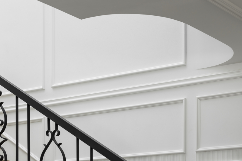 Classical Marriage classic staircase with white wall panels close up view mieux interior design