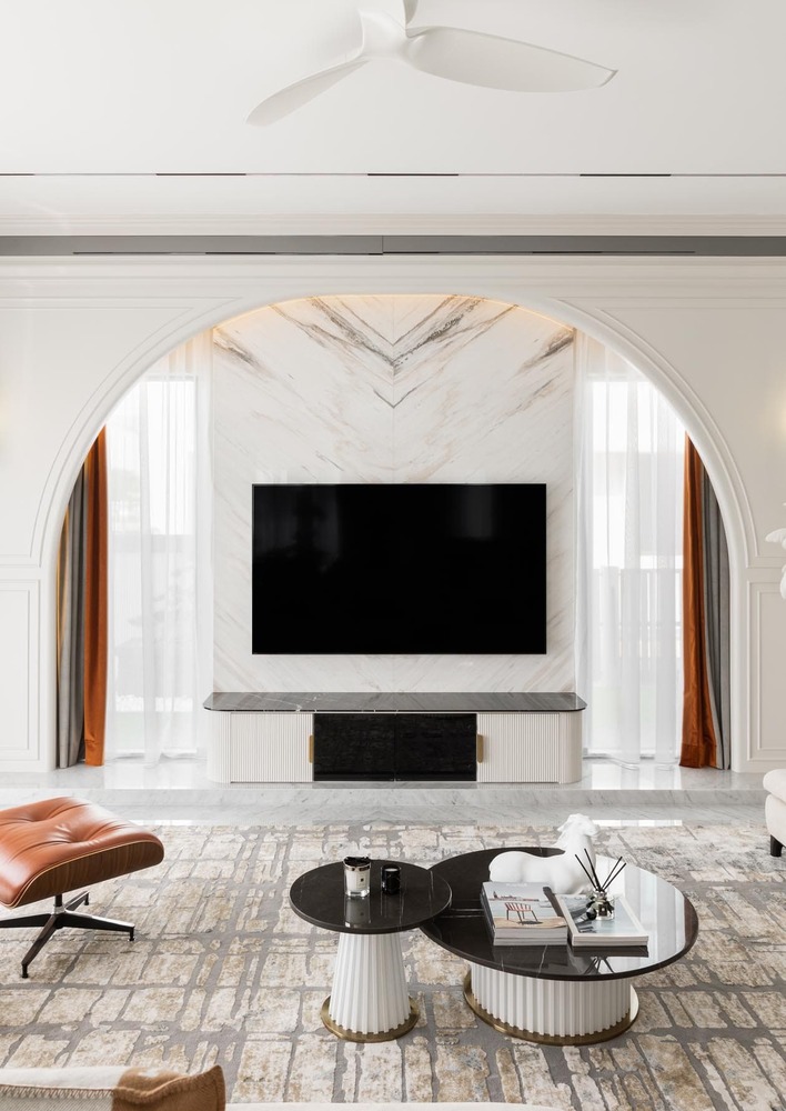 Luxurious living room with curve wall, marble flooring and modern design carpet