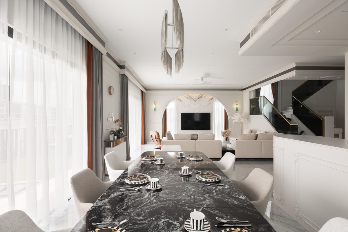 Milady Fantasy white and black theme dining area with black marble table and unique hanging light mieux interior design