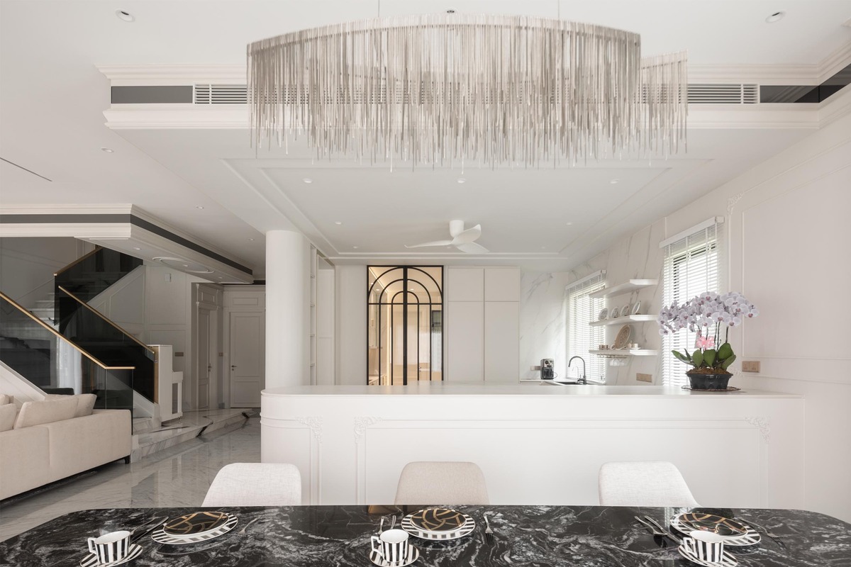 Milady Fantasy white and black theme dining area with black marble table and unique chandelier mieux interior design