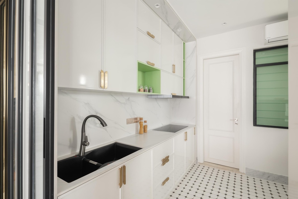 Milady Fantasy white theme kitchen with white marble countertop, black sink and a hint of green color mieux interior design