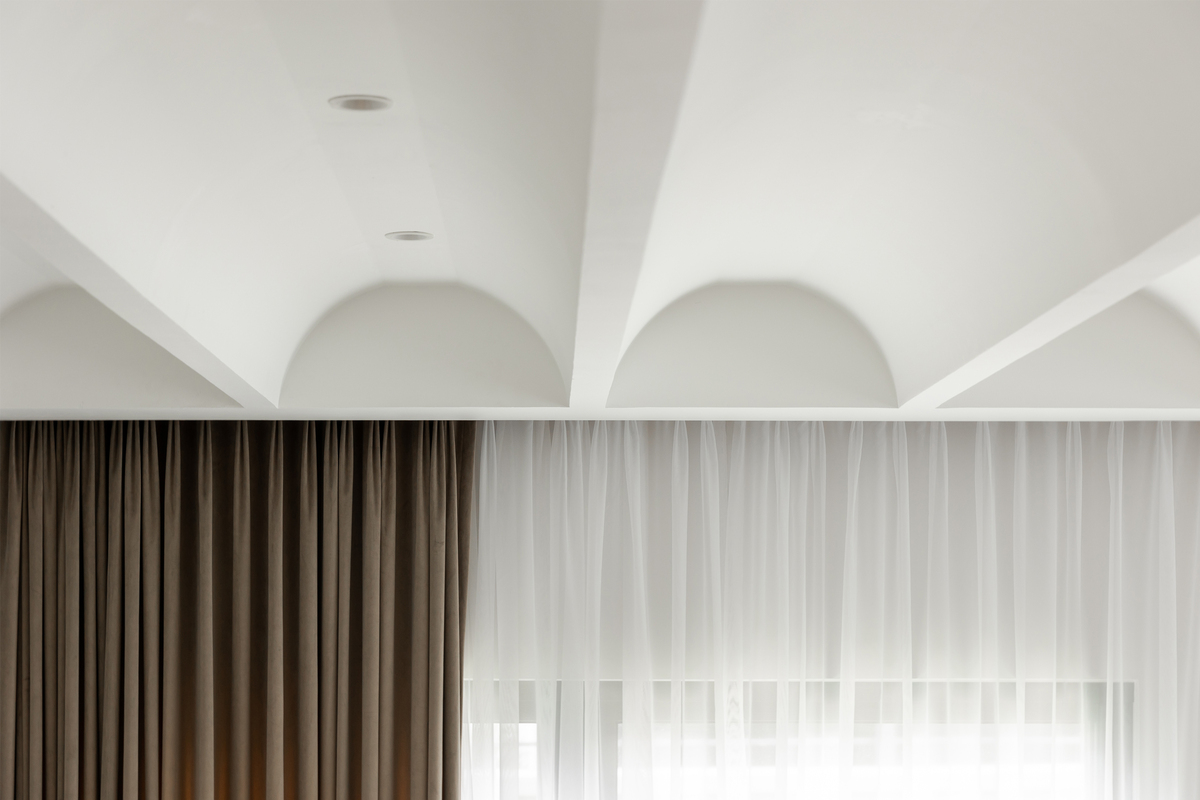 Curvy ceiling and hidden curtain interior design